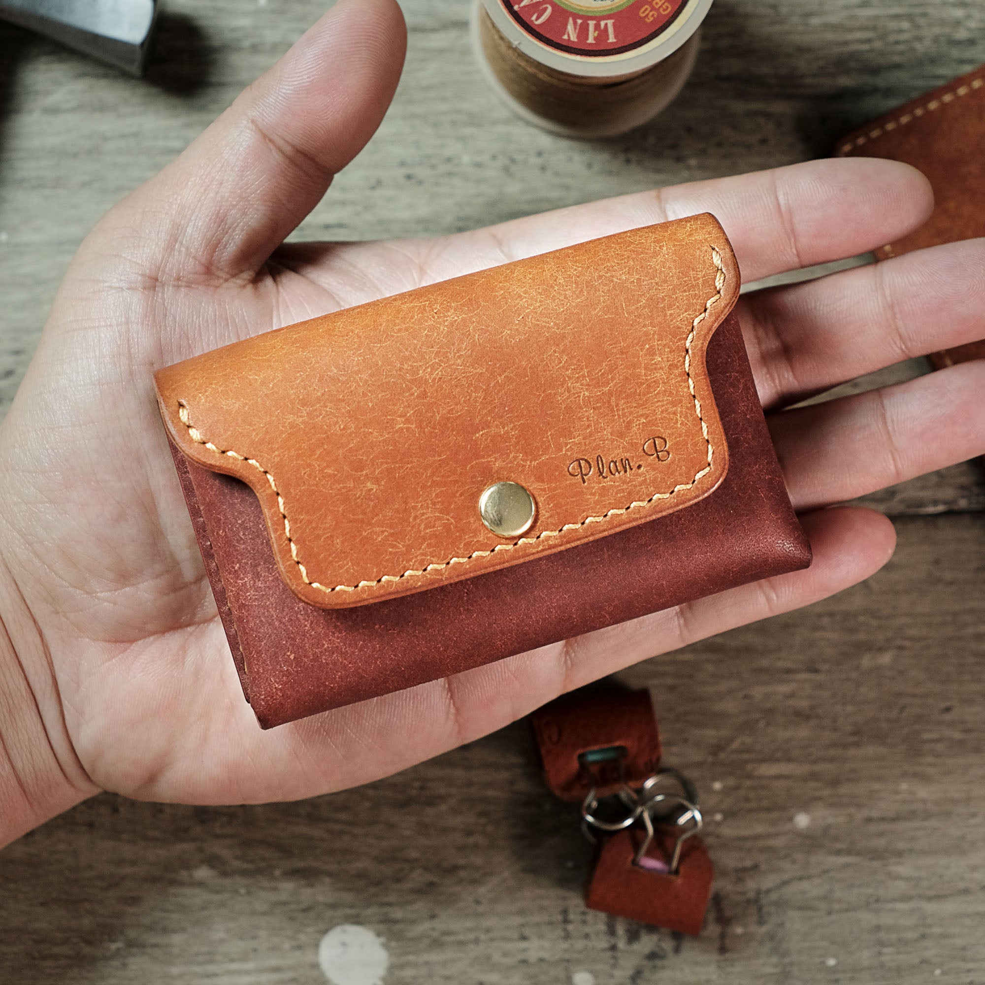 Compact Plump Wallet resting on a palm, highlighting its small size and portability.