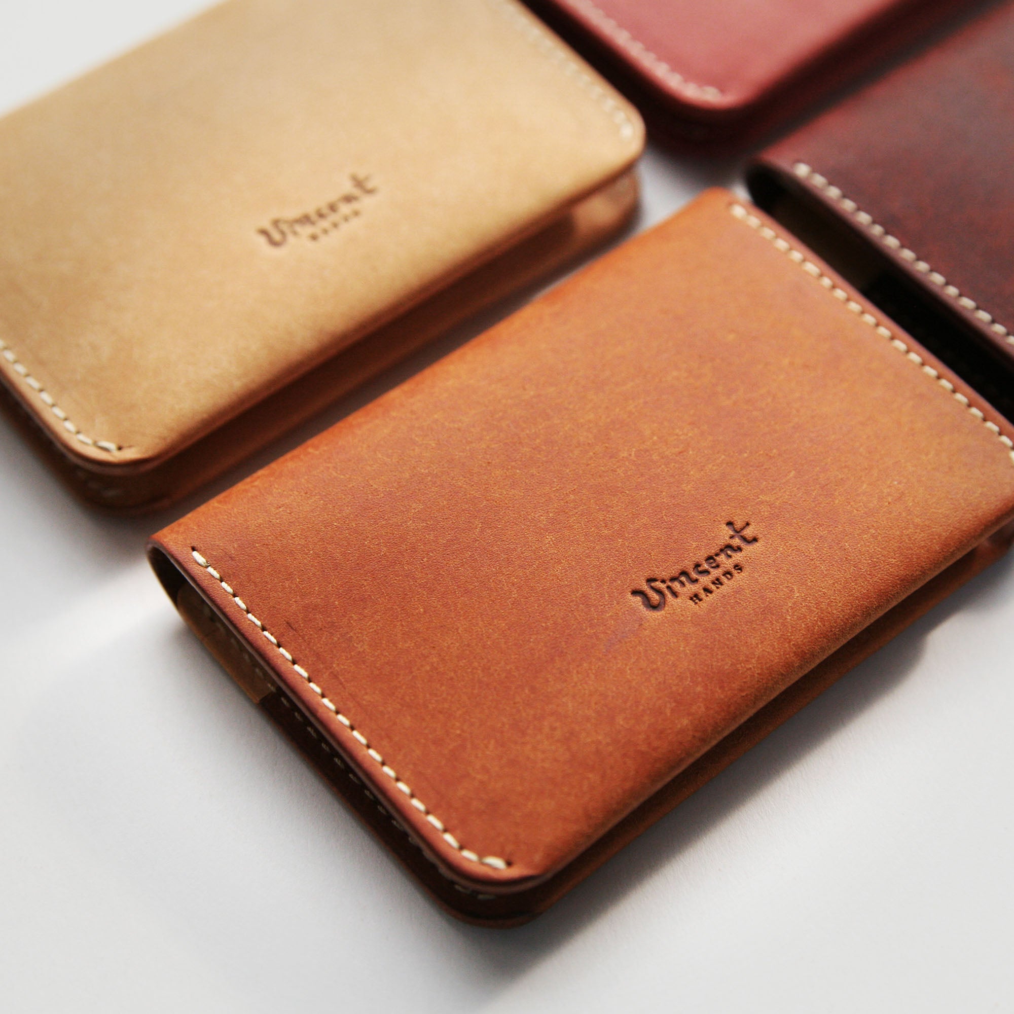 Collection of closed 6 Pocket Wallets in assorted colors, displaying compact size and simple style.