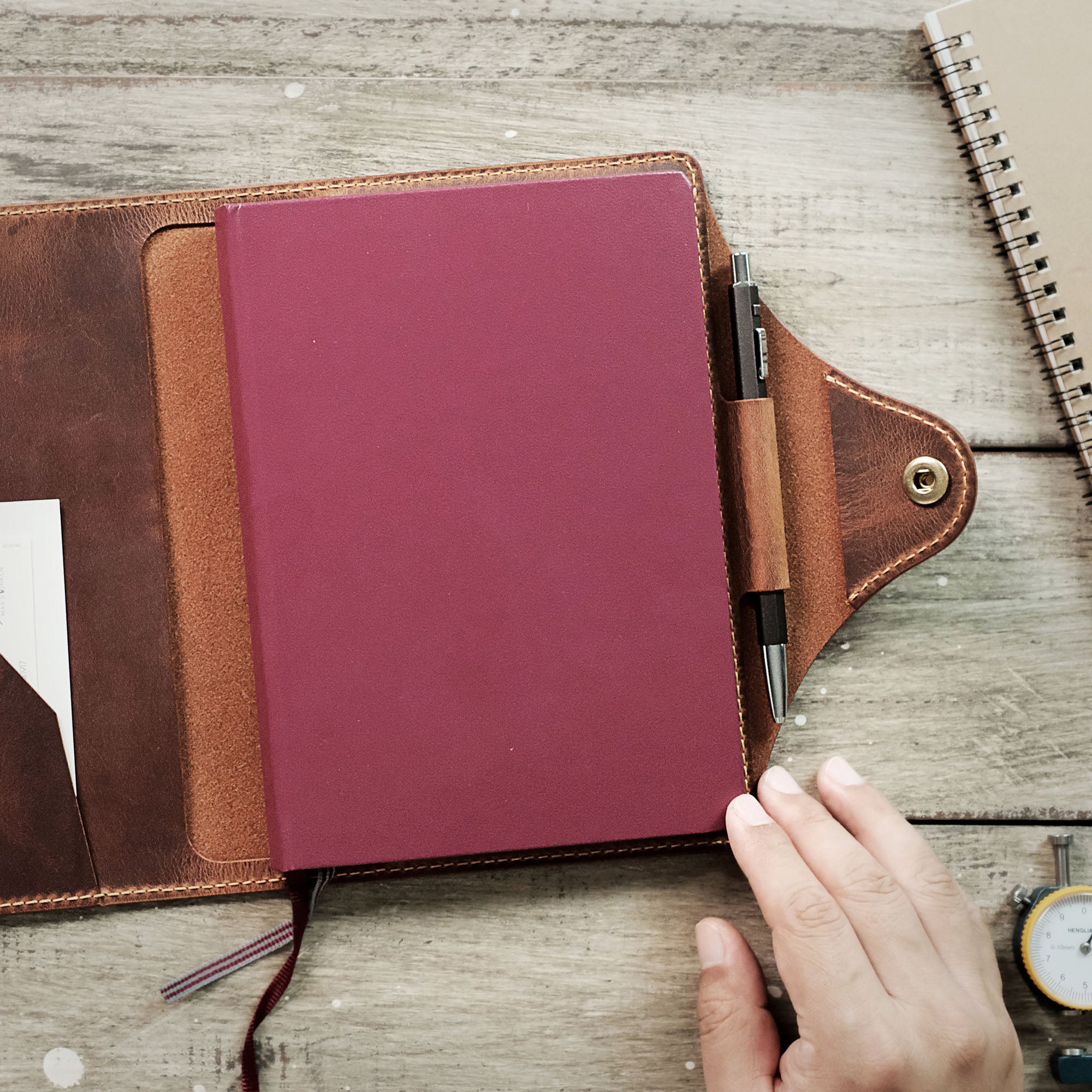 Leather A5 Notebook Cover with a pen and notebook neatly stored inside.