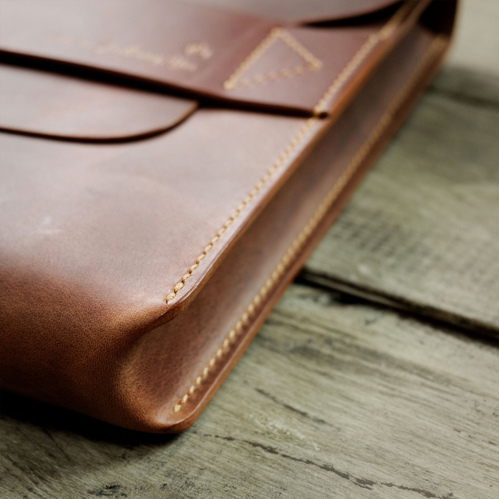 Zoomed-in side view of the briefcase, focusing on the sturdy edges and overall thickness.