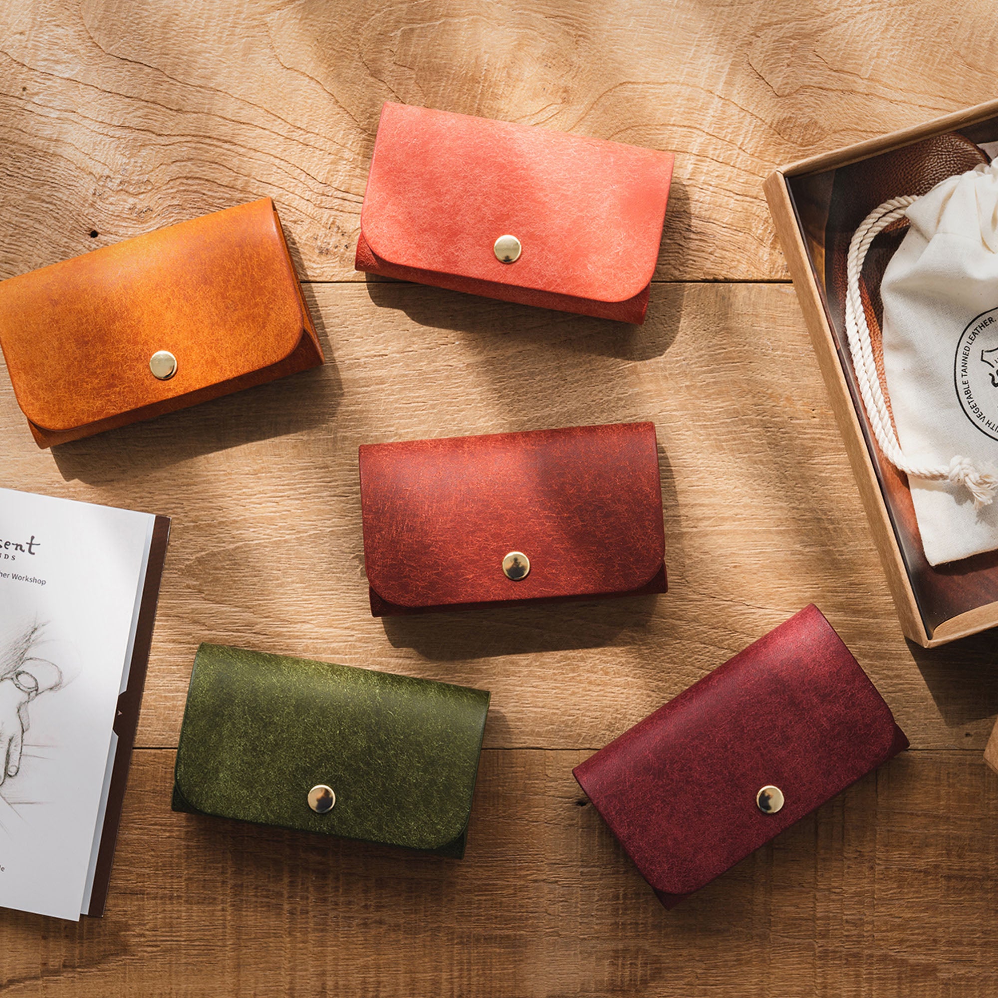 Top-down shot of four Business Card Wallets in brown, green, pink