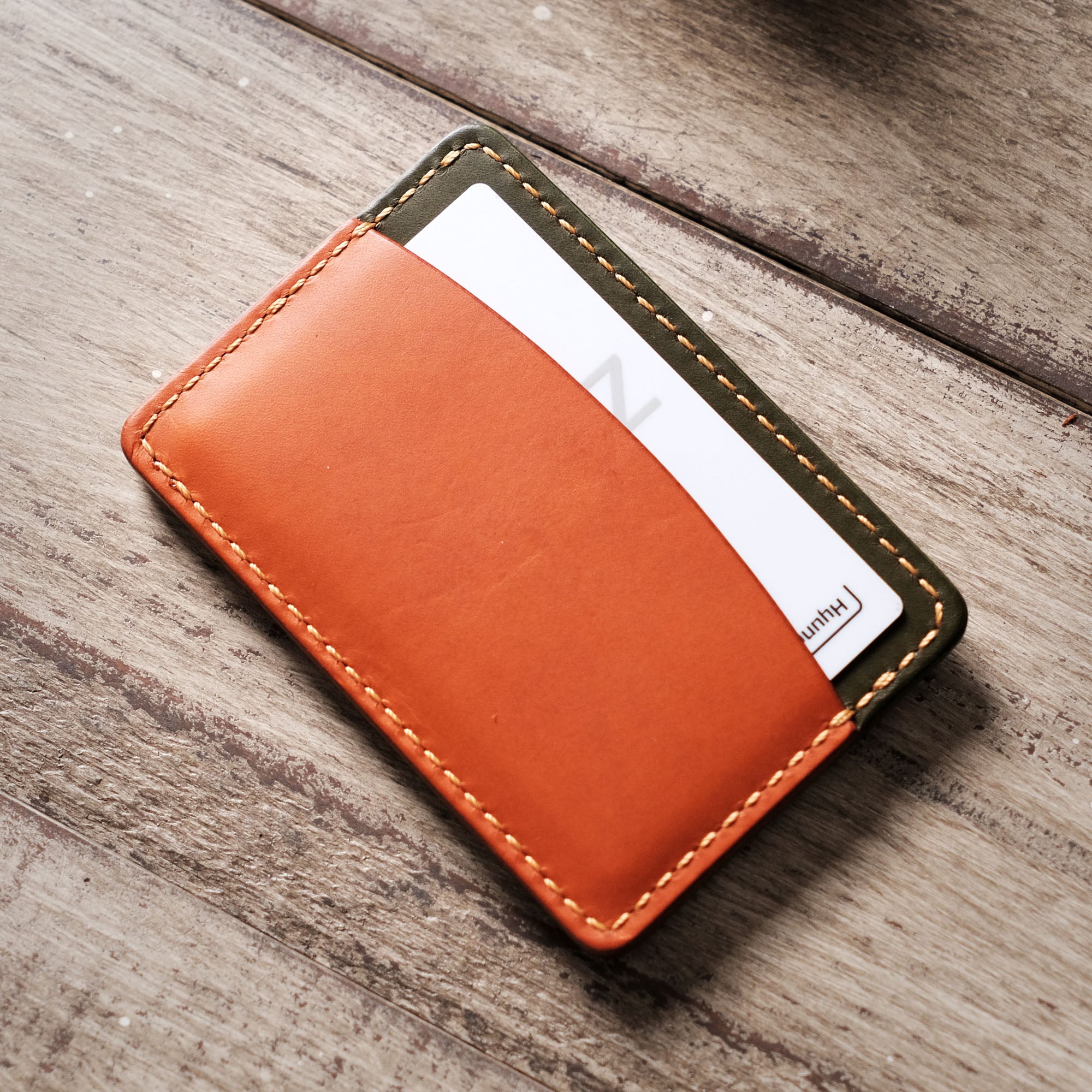 Back view of the card holder with a single card inserted into the rear pocket.