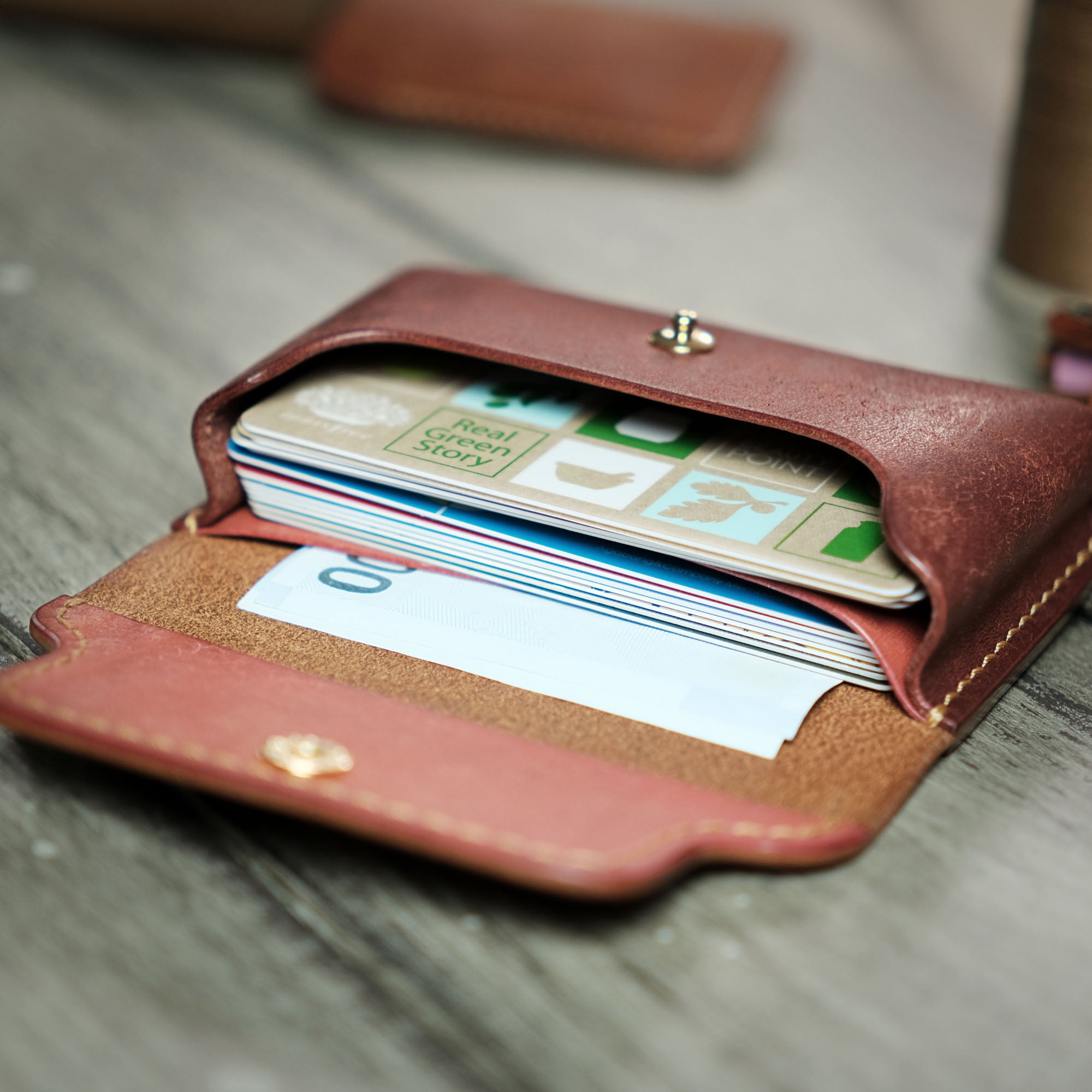 Open view of the Compact Plump Wallet with numerous cards and bills neatly stored inside.