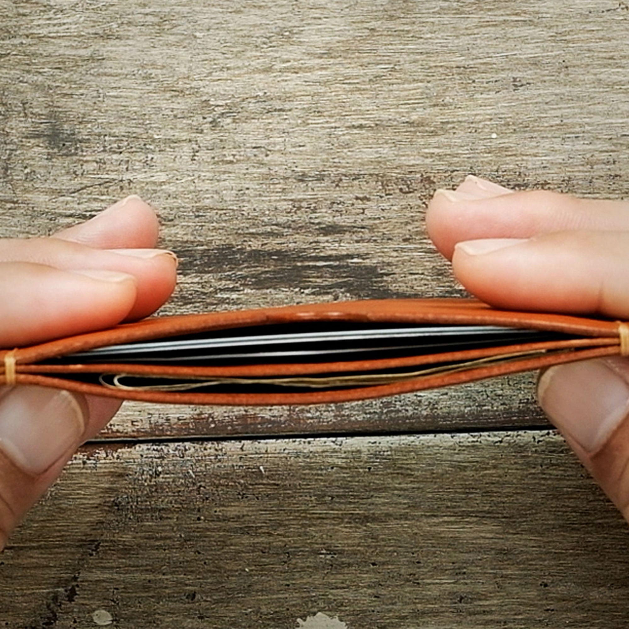 View of cards and cash stored inside the Minimalist Wallet, highlighting efficient organization.