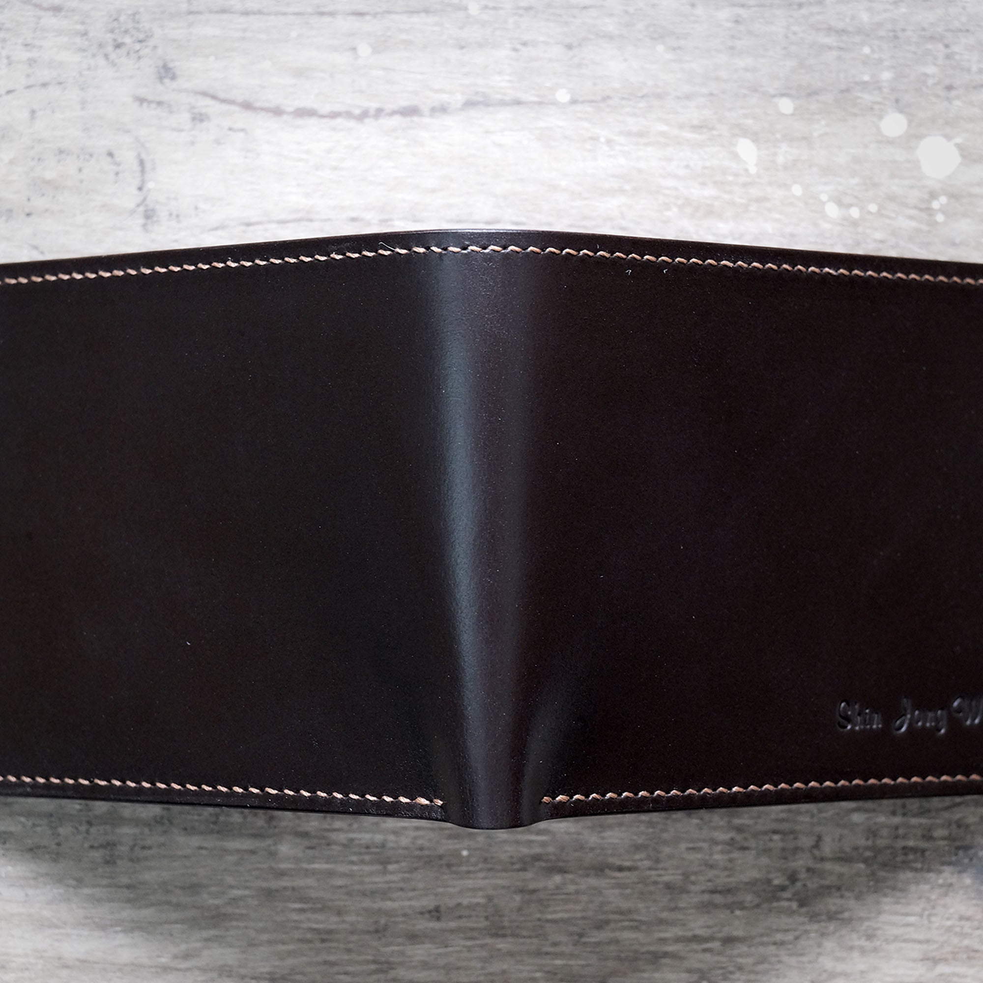 Back view of the Billfold Wallet, highlighting the detailed stitching along the edges.