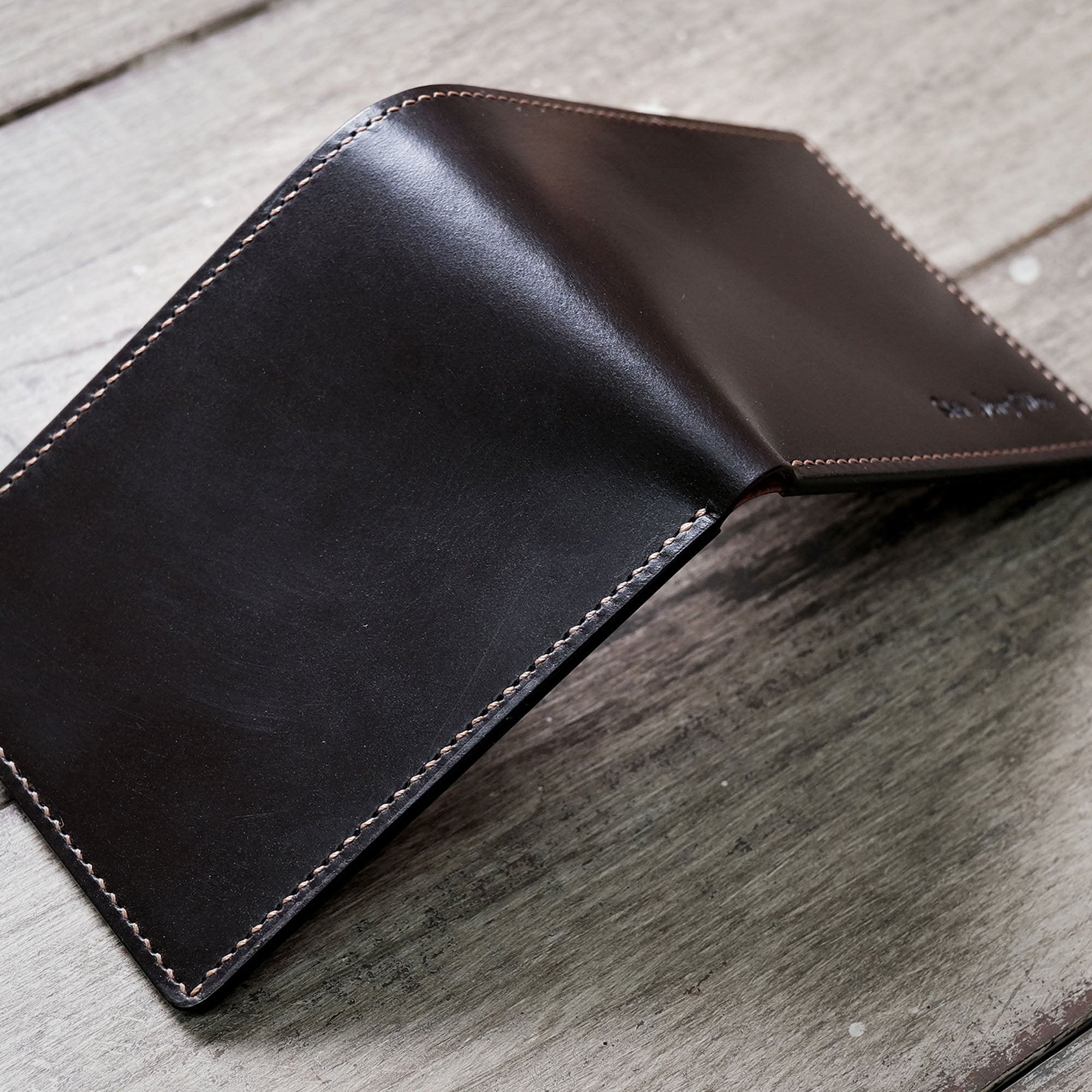 Detailed angled shot of the Billfold Wallet’s back, emphasizing its gentle texture and stitching.