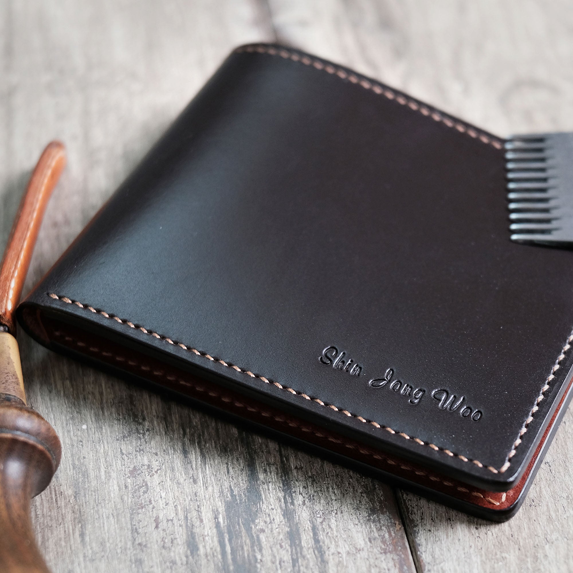 Angled view of the Billfold Wallet in a folded position, showcasing its slim profile and smooth leather.