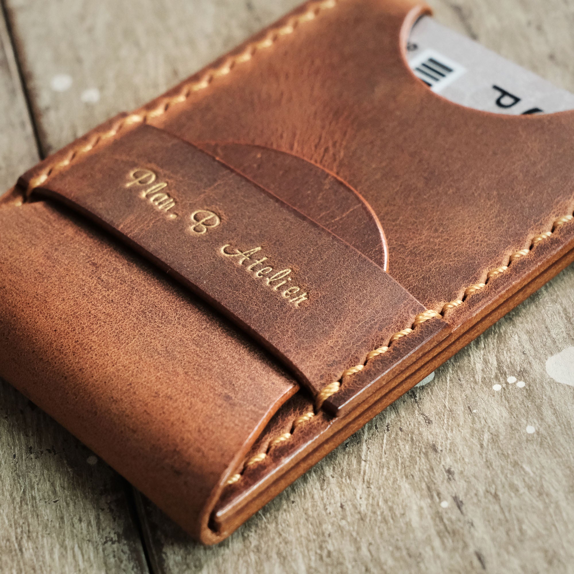 Angled view of the Pop-Up Card Holder with the flap securely fastened by a horizontal strap.